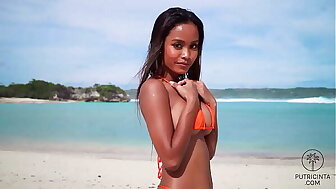 Putri Cinta stripping on a elegant tropical beach